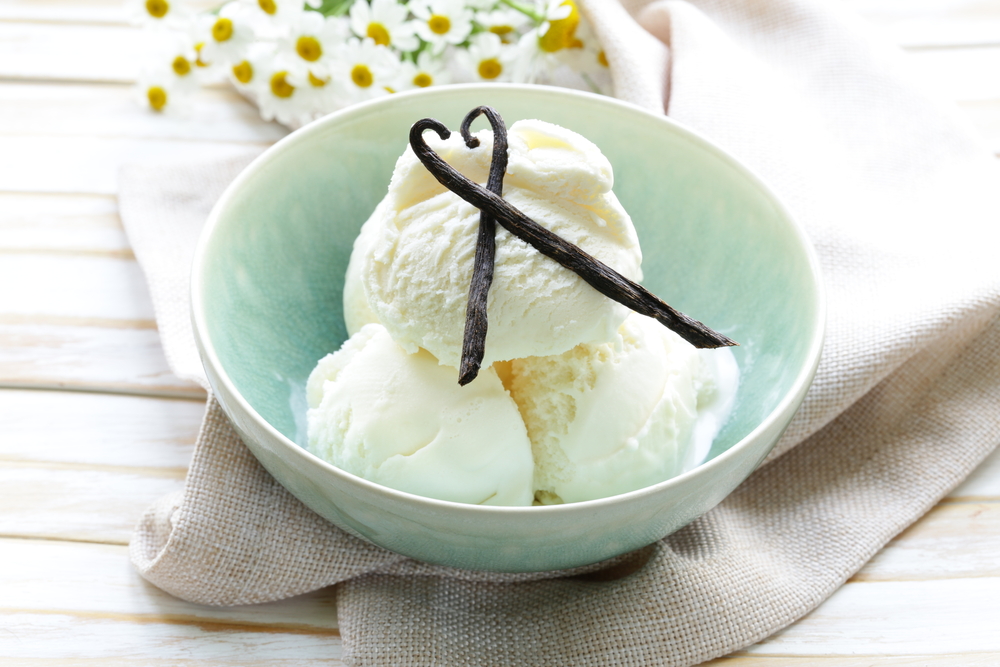 Domáca vanilková zmrzlina servírovaná v miske ozdobená vanilkovými luskami.